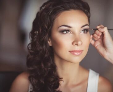 woman having makeup done