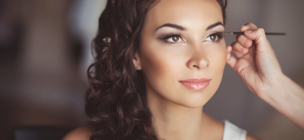 woman having makeup done