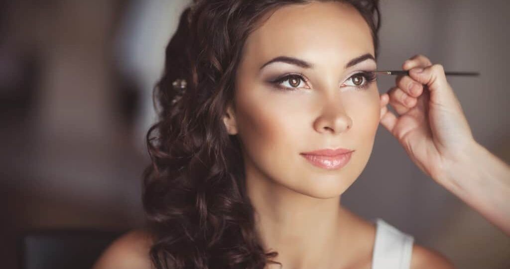 woman having makeup done