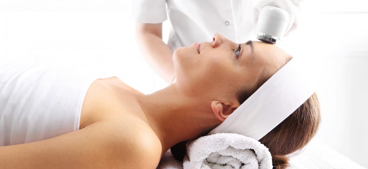 esthetician using ultrasound tool for skin care in Guelph