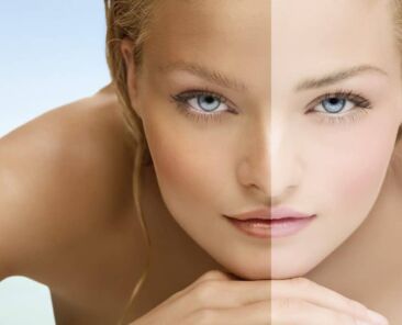 Beauty visual about suntan. Model's face divided in two parts - tanned and blanc.
